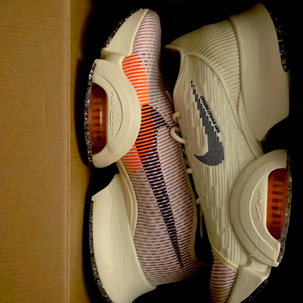 Beige and orange Nike workout shoes